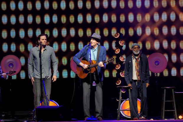 James Taylor's aptly named All-Star Band features four vocal accompanists, including his son Henry, at left, and Dorian Holley at right. (Nelvin C. Cepeda / The San Diego Union-Tribune)