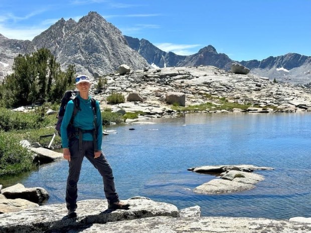 Valerie Ross, a trip leader for San Diego Girl Scouts' backpacking program, stands on Darwin Bench above Evolution Basin in Kings Canyon National Park. (Courtesy of Valerie Ross)