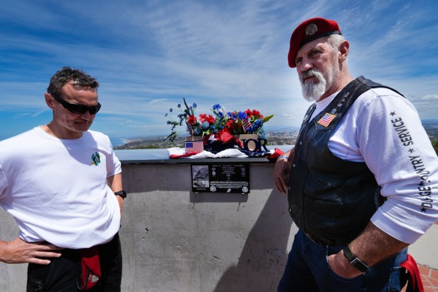 Travis Woodworrth (l), USAF Col., Ret., and Kyle Stanbro (r), USAF Master Sgt., Ret., who served with "Chappy," stood next to the plaque for United States Air Force Master Sergeant John A. "Chappy" Chapman at Mt. Soledad National Veterans Memorial on Wednesday, April 22, 2026, in San Diego. Master Sergeant Chapman distinguished himself by extraordinary heroism as a Special Tactics Combat Controller while attached to a Navy SEAL team during the Battle of Takur Ghar in Afghanistan on March 4, 2002. (Nelvin C. Cepeda / The San Diego Union-Tribune)