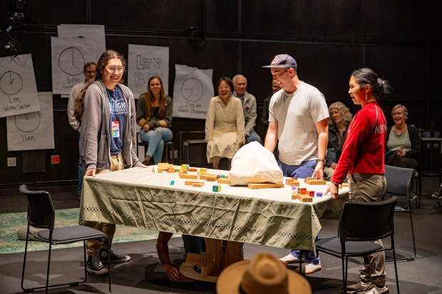 Audience members help Jeff Crocker, center, keep life in balance in Mister and Mischief's "Again! Again!" at La Jolla Playhouse's 2026 WOW Festival at UC San Diego. (Jenna Gilmer)