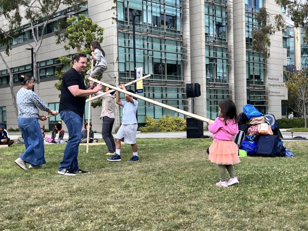 Parents and children collaborate in "Carry On," a family performance art piece from France's Cie Presque Siamoises troupe at La Jolla Playhouse's 2026 WOW Festival at UC San Diego in La Jolla. (Pam Kragen / The San Diego Union-Tribune)
