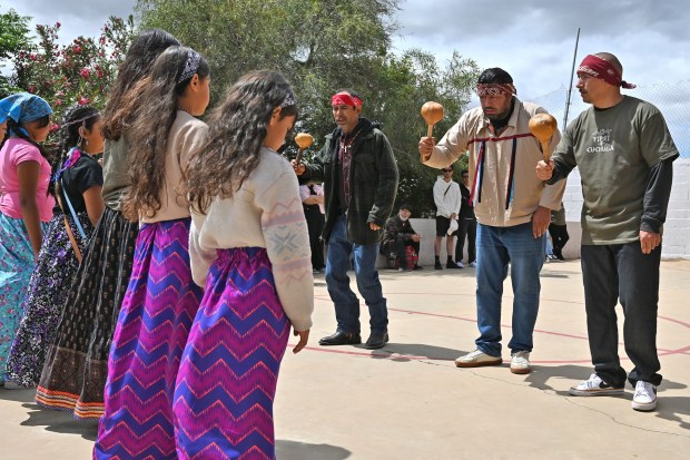 Members of native communities, mainly Kumeyaay native group, during a "ceremony" rally against the destruction of the Kuchamaa Mountain left by the construction of a new border wall at the US-Mexico Border in Tecate, Baja California, Mexico on Sunday, April 12, 2026. The Kuchamaa Mountain is considered a sacred site by native groups living in both sides of the border. (Carlos Moreno / The San Diego Union-Tribune)