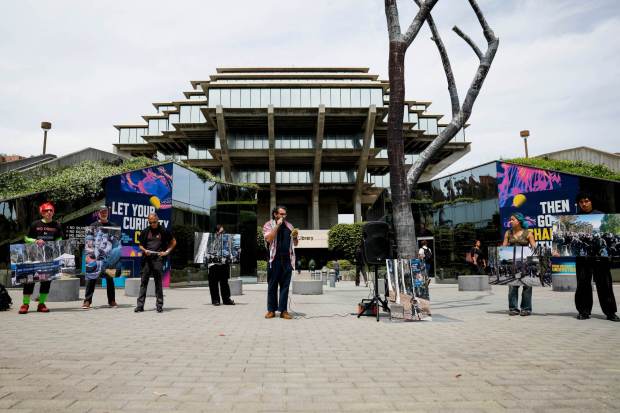 Anthony Harb, Assistant Professor of Communication at USCD, center, speaks during a protest and press conference outside the Geisel Library on Thursday, April 9, 2026 in San Diego, California. The protest was regarding the upcoming disciplinary hearings relating to 2024 UCSD Gaza protest encampment arrests. (Meg McLaughlin / The San Diego Union-Tribune)