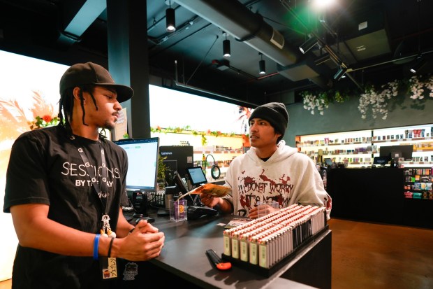 National City, CA - April 16: On Thursday, Jalen Fant, a budtender with Session by the Bay in National City, assisted Jesse Lucas with selecting a cannabis.  (Nelvin C. Cepeda / The San Diego Union-Tribune)
