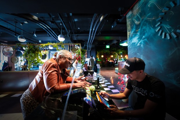 National City, CA - April 16: Annette Pearson checks in Issac Torres to make reservations for the weekend celebrating the 420 special event at Session by the Bay in National City. (Nelvin C. Cepeda / The San Diego Union-Tribune)