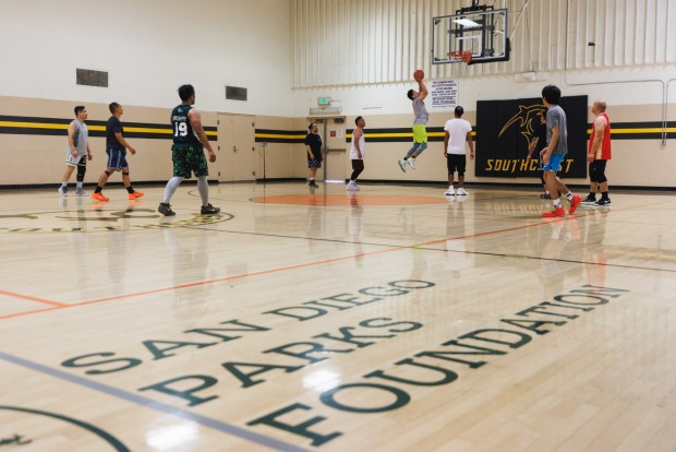 The "Southcrest Ballers,"a Filipino group that rents out the basketball court every Saturday, play at Southcrest Recreation Center on Saturday, April 18, 2026. (Kristian Carreon / The San Diego Union-Tribune)