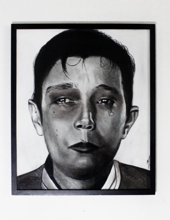 A black and white portrait of a person with short hair and eyes that are shiny with tears. One tear is falling from the left eye.