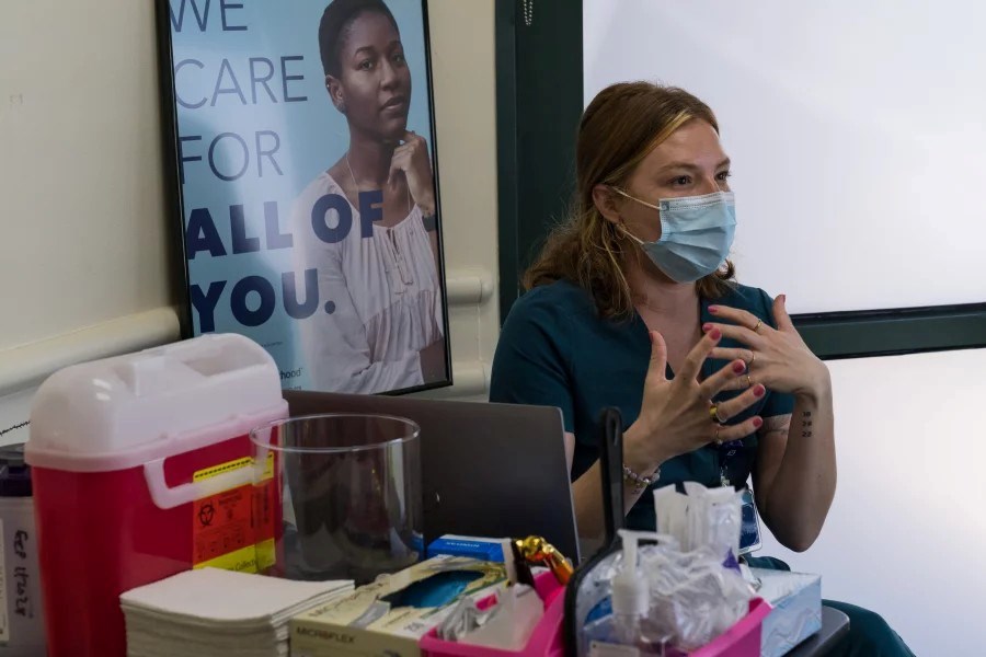 Samantha Pohlman, a registered nurse, speaks with a patient prior to cosmetic treatment at Planned Parenthood in Sacramento, Calif.