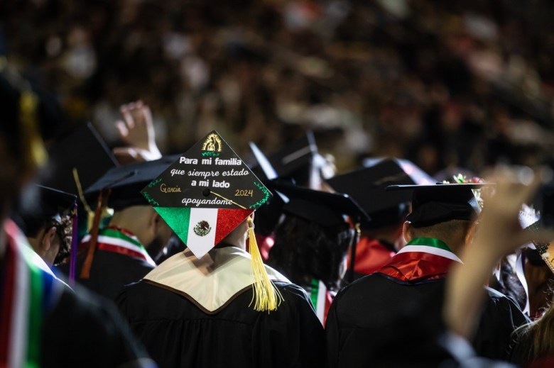 Graduating students take their seats at the Fresno State Chicano/Latino Commencement Celebration in the Save Mart Center in Fresno on May 18, 2024. Photo by Larry Valenzuela, CalMatters/CatchLight Local