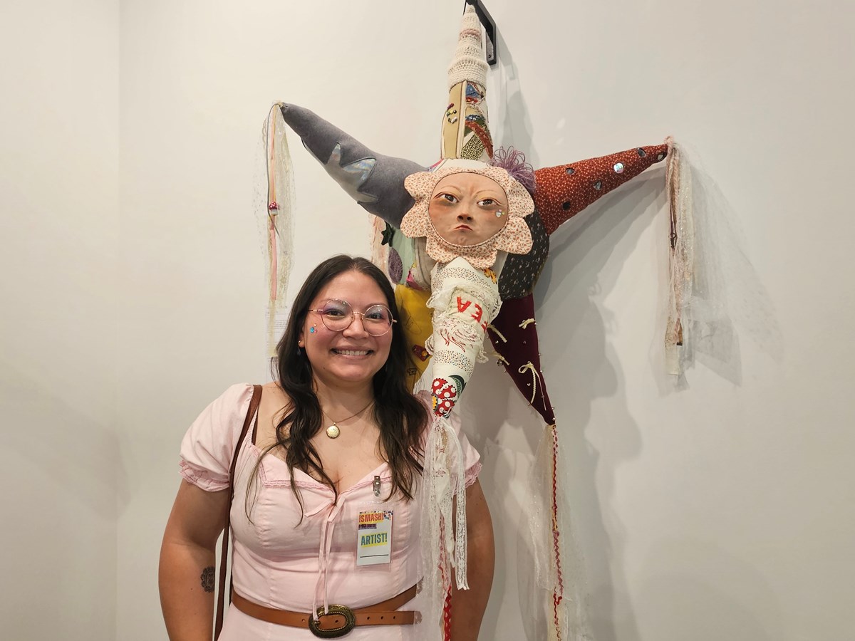Andrea Lizalde-Valencia’s piece follows the piñata’s traditioanl seven-cone shape, but features a crying face made of clay and seven fabric cones, each highlighting a different aspect of her life.