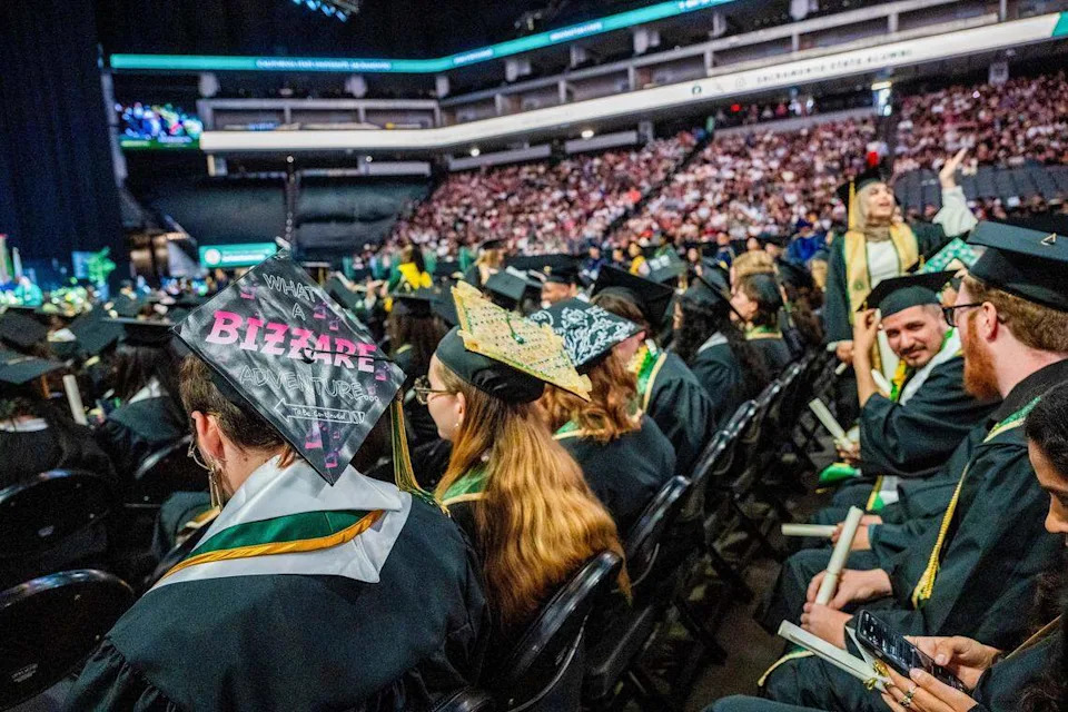 Sacramento State graduates wear decorated mortarboards during one of the school's commencement ceremonies at Golden 1 Center on Friday. The university is celebrating the largest graduating class in its history.