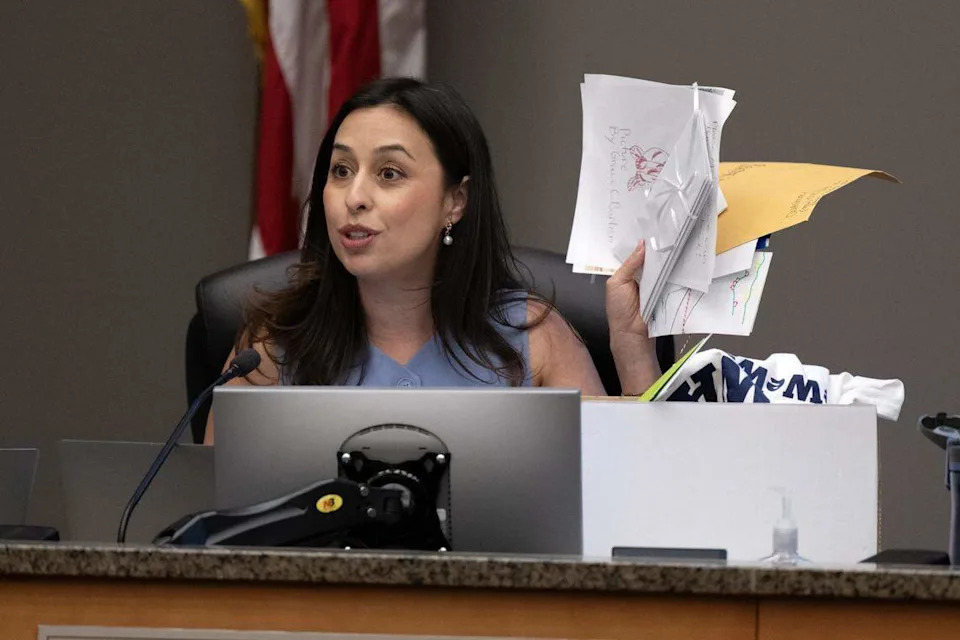Sacramento City Councilmember Karina Talamantes holds up letters from children hoping to prevent the Sacramento Zoo’s relocation before the vote to study its expansion in William Land Park during a council meeting on Tuesday.