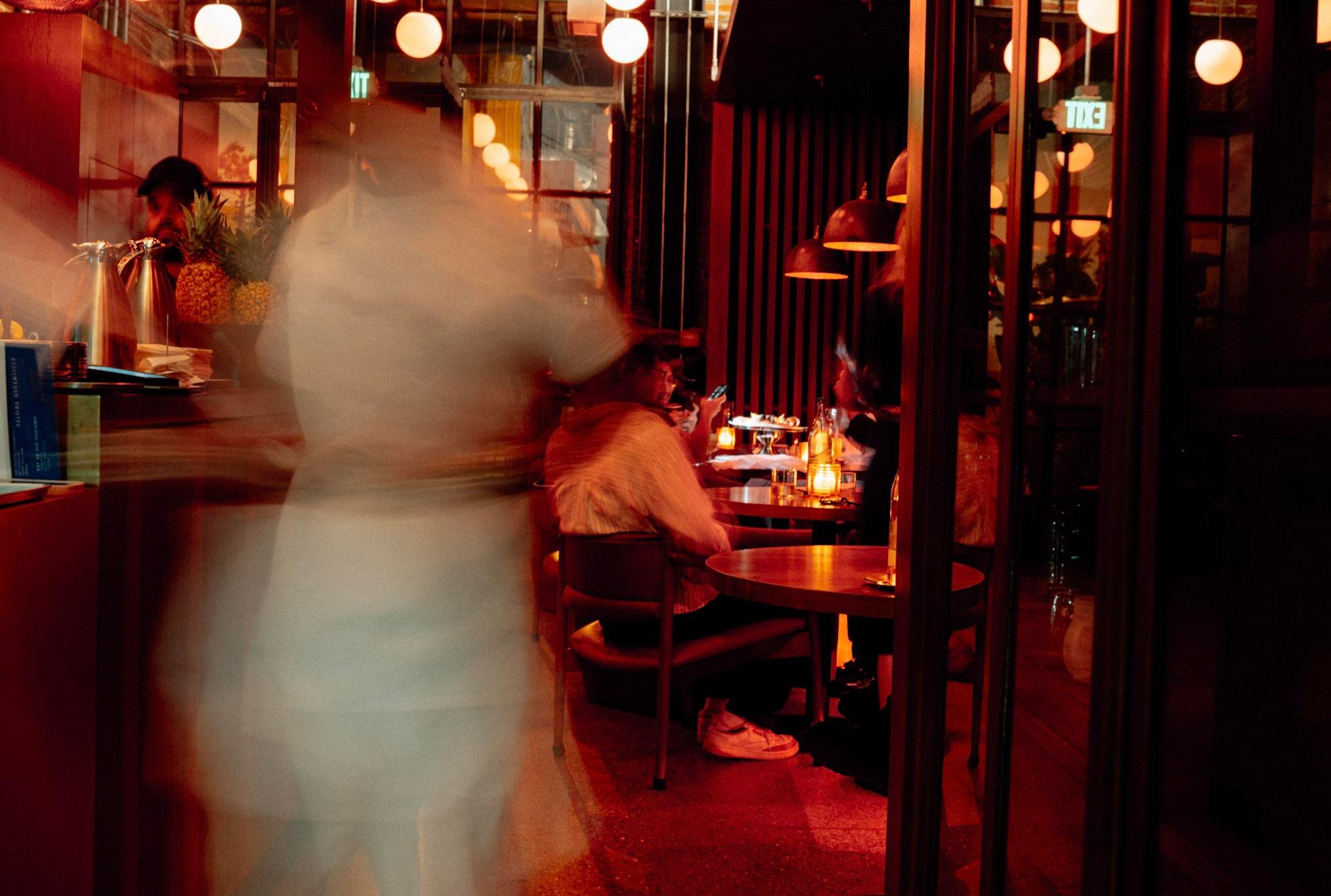 Interior of Lynx with dim lighting and guests dining.