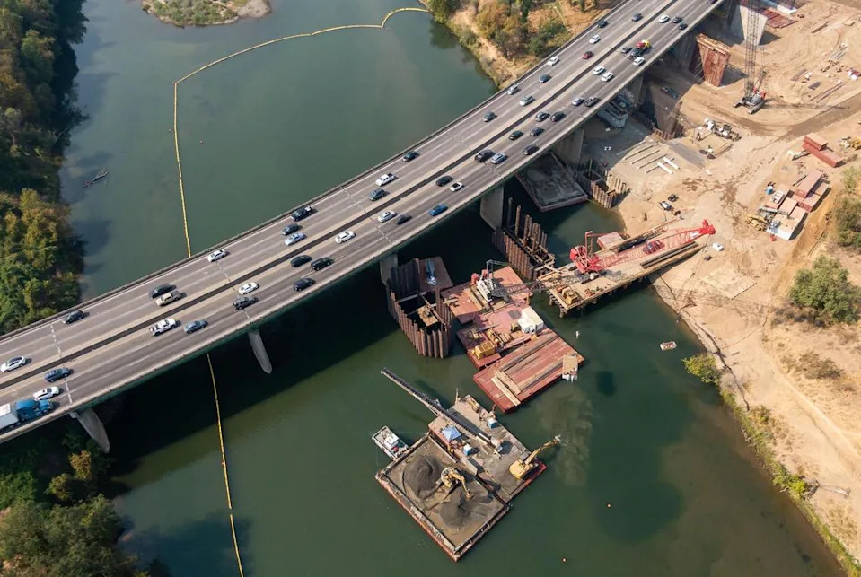 A drone captures early construction on the Capital City Freeway bridge over the American River on Sept. 9, 2022, near Cal Expo in Sacramento. The $211 million Caltrans project will widen the 71-year-old span and add bike and pedestrian access linking to the American River Parkway.