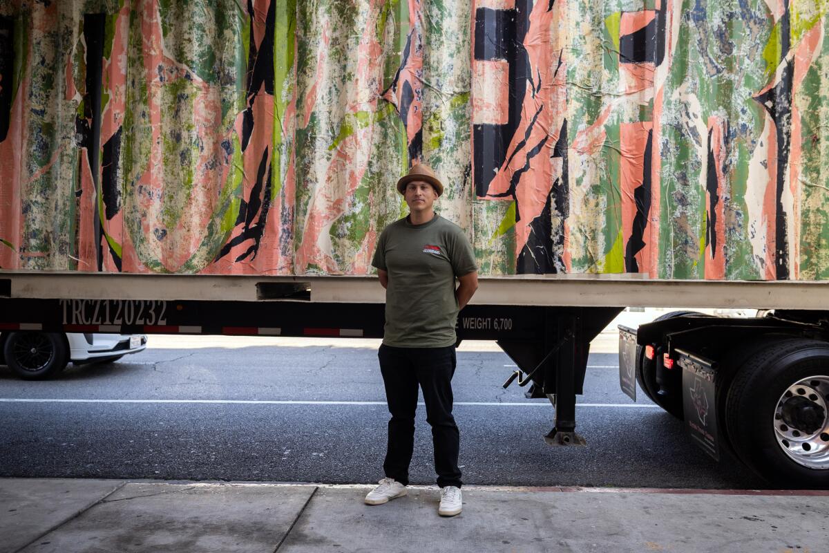 LA-based artist Edgar Ramirez poses in front of his art piece entitled "I want to be free" 