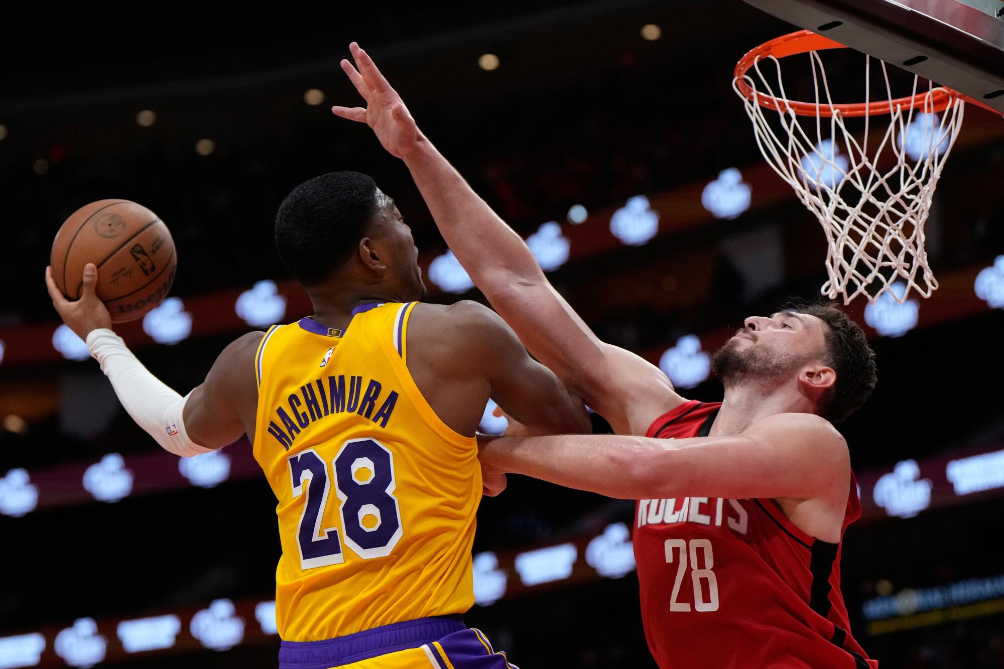 Lakers forward Rui Hachimura, left, elevates for a layup against Rockets center Alperen Sengun, right, during Game 6.