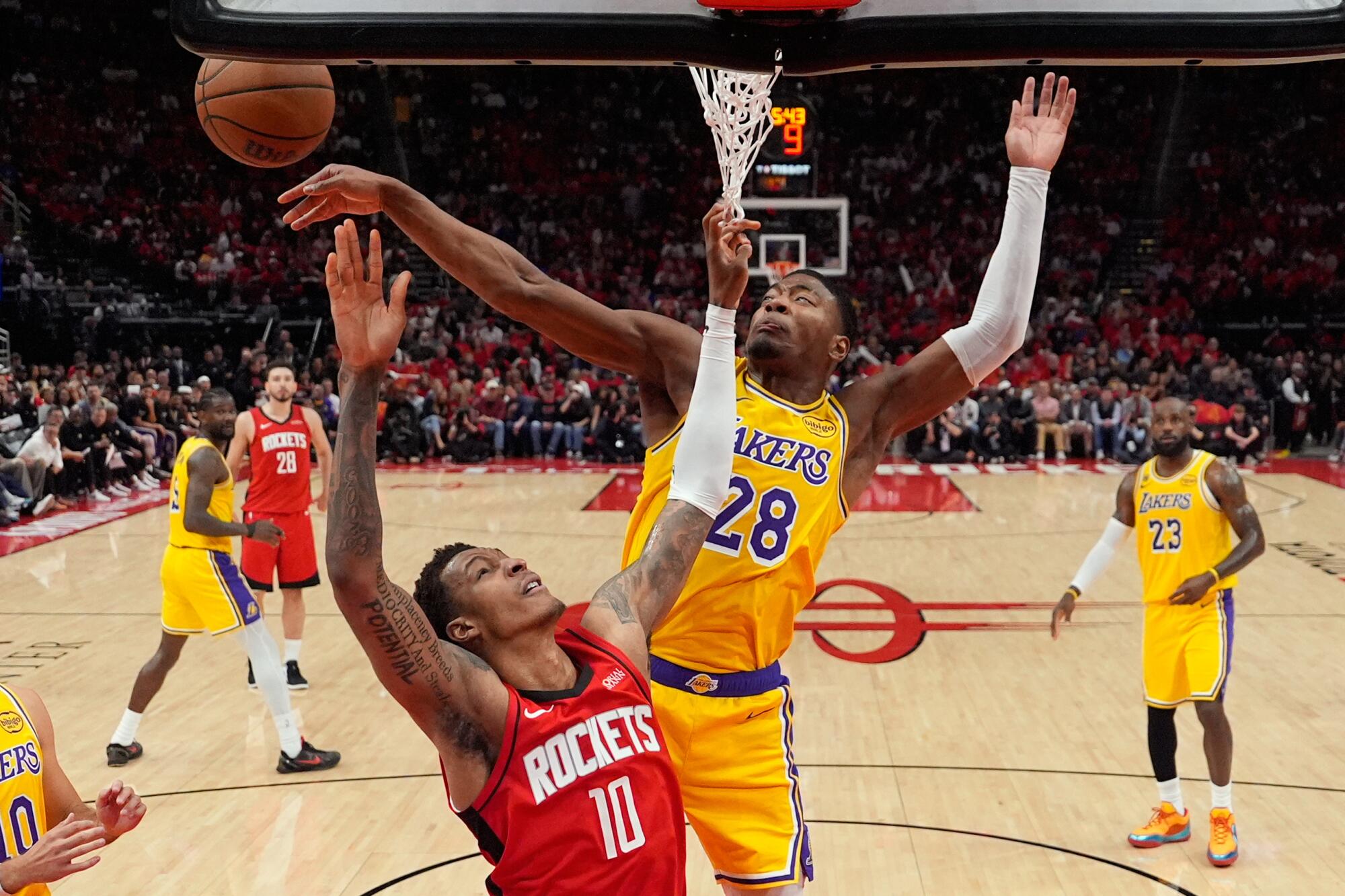 Lakers forward Rui Hachimura, right,blocks a shot by Rockets forward Jabari Smith Jr., left, during the first half of Game 6.