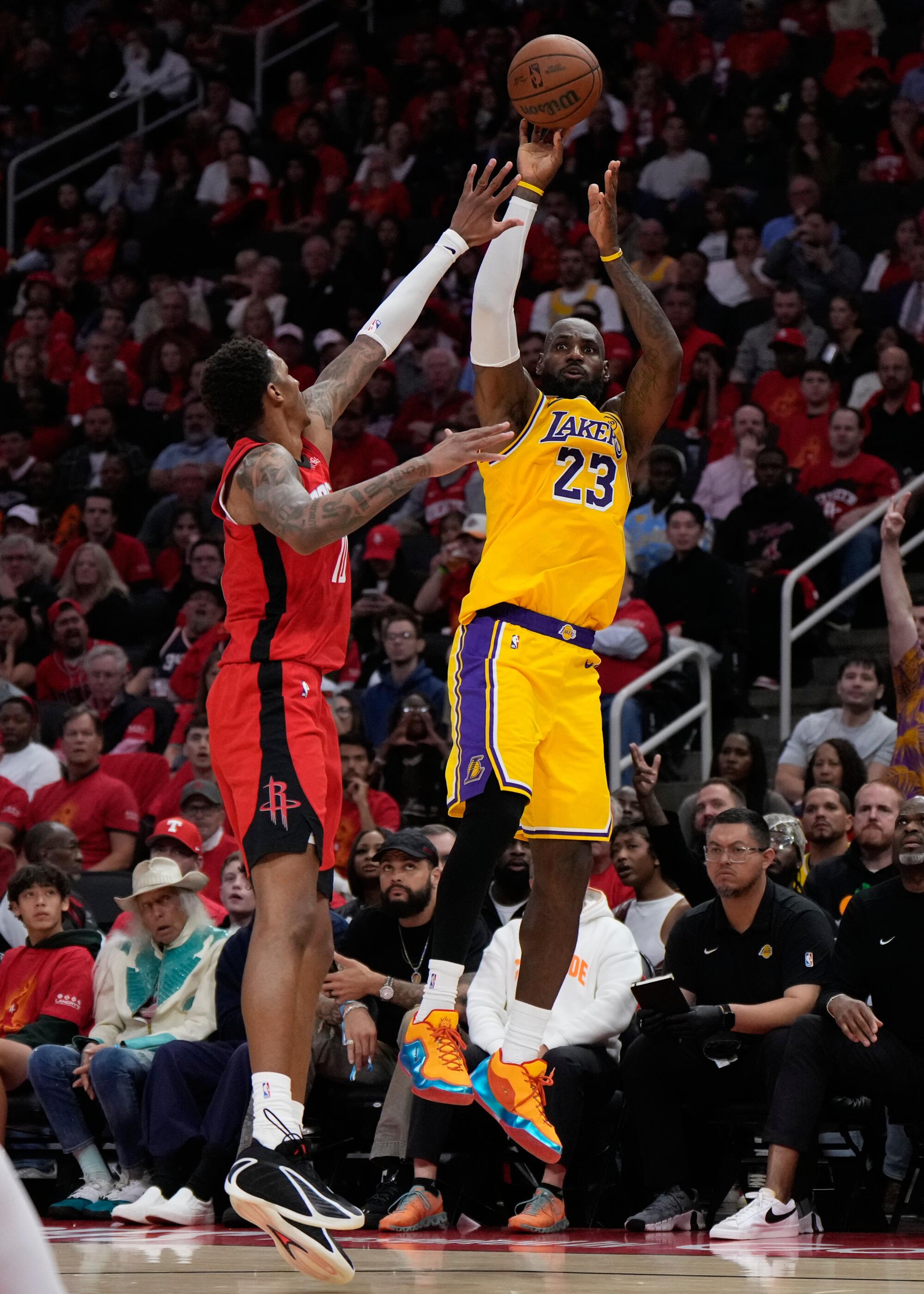 Lakers forward LeBron James, right, over the outstretched arm of Rockets forward Jabari Smith Jr., left, during Game 6.