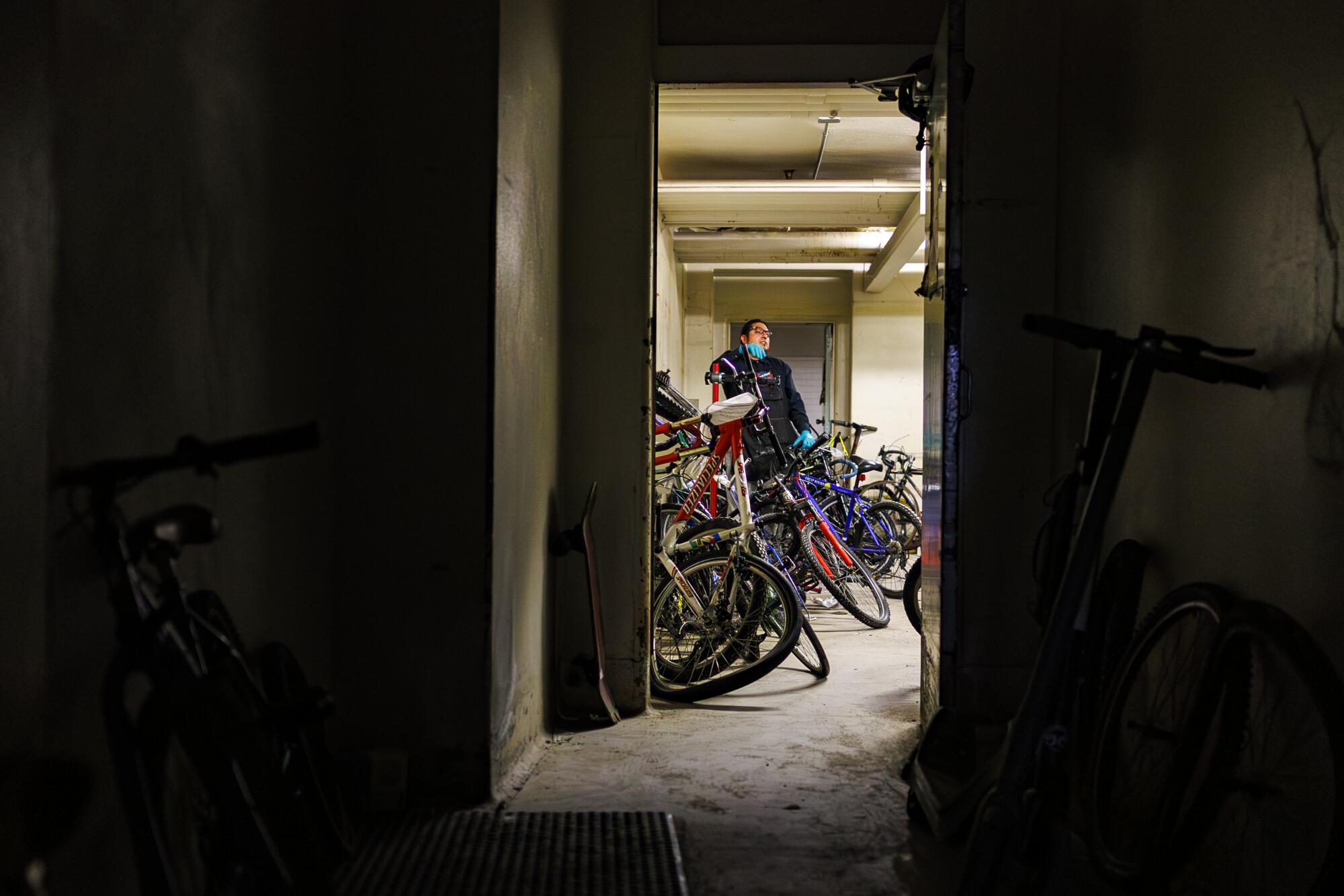 Olin Reyes repairs abandoned bikes in a dusty basement of the shuttered General Hospital