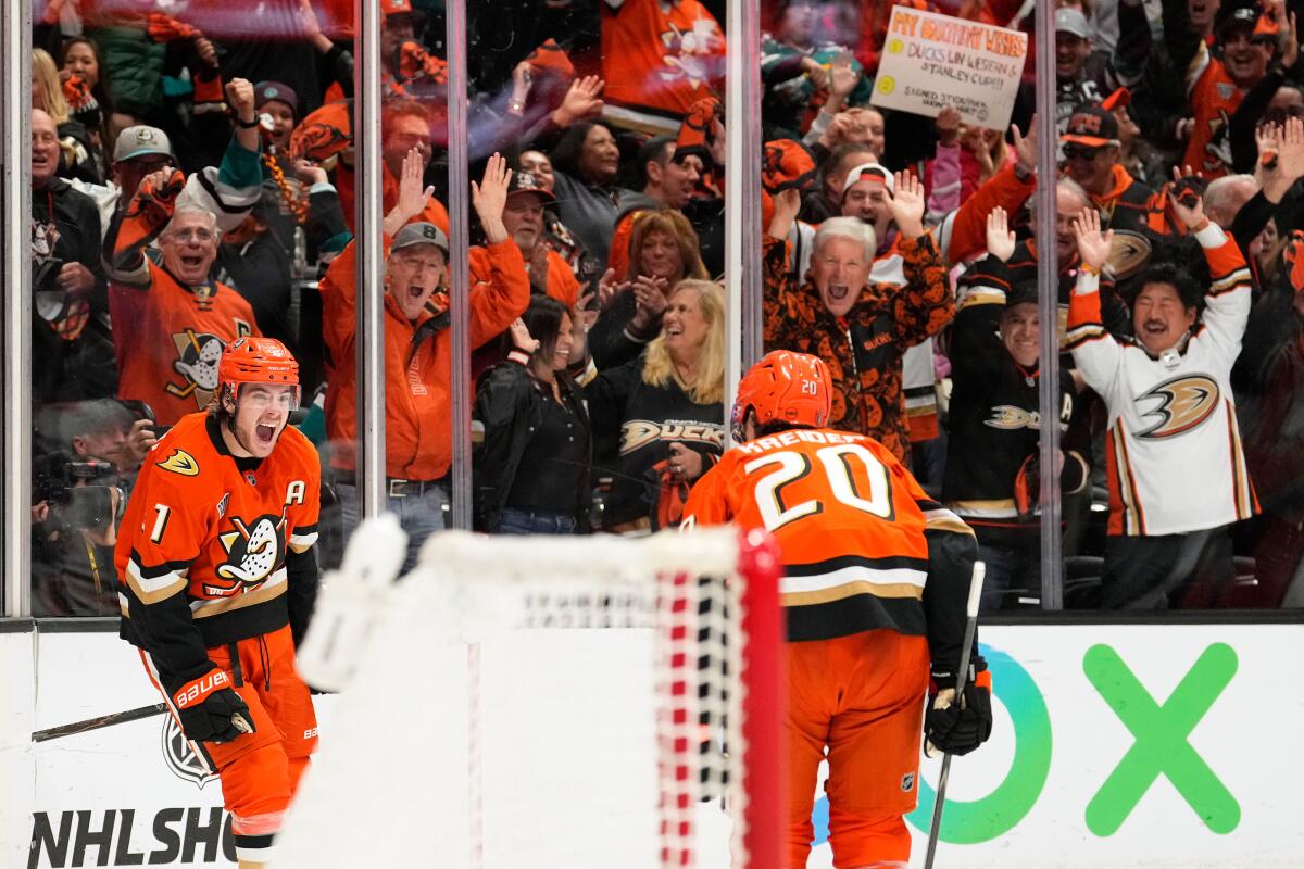 Ducks center Leo Carlsson celebrates with left wing Chris Kreider after scoring an empty net goal during Game 6.