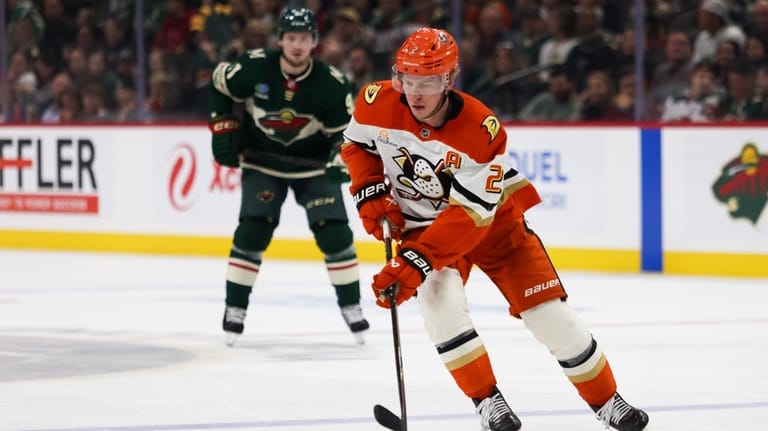 Anaheim Ducks' Jackson LaCombe (2) controls the puck against the...