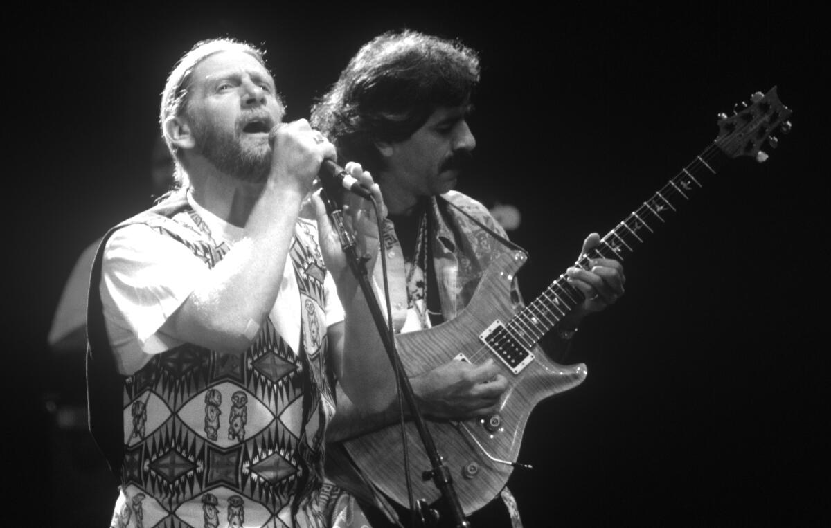 Alex Ligertwood and Jorge Santana of Santana band perform at Shoreline Amphitheatre in 1993