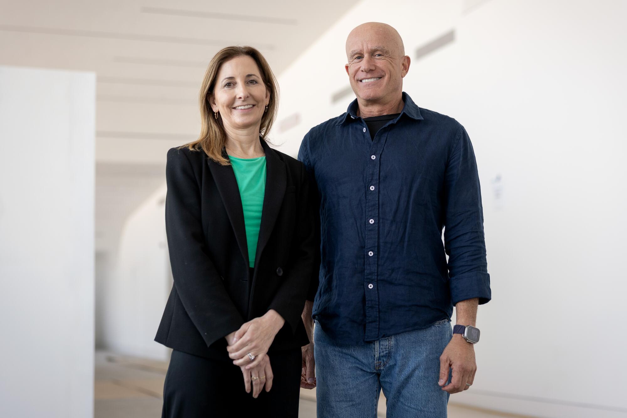 Two people in front of a museum.
