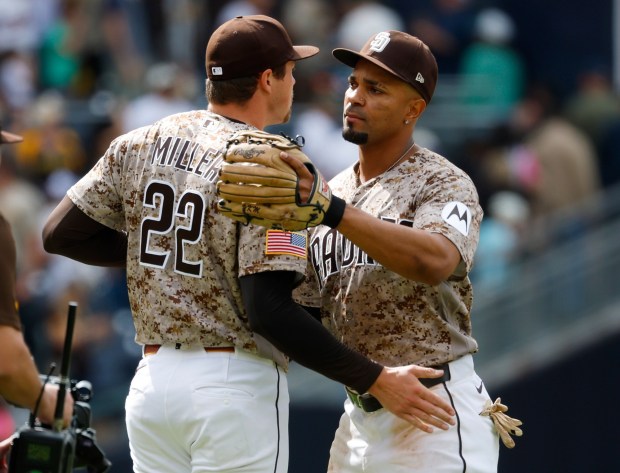 Mason Miller #22 of the San Diego Padres celebrates with catch Xander Bogaerts #2 after a 4-3 win against the Chicago White Sox at Petco Park on May 3, 2026 in San Diego, CA. (K.C. Alfred / The San Diego Union-Tribune)