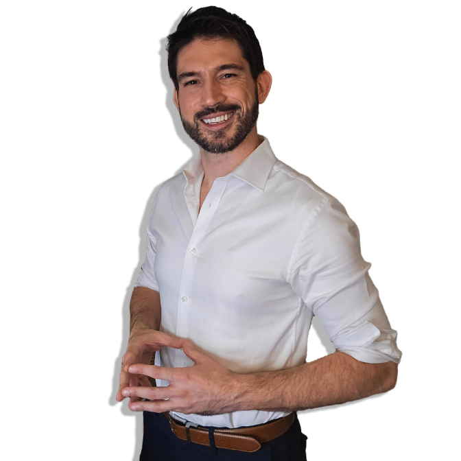 A white man with dark hair and a full beard smiles and poses for the camera.