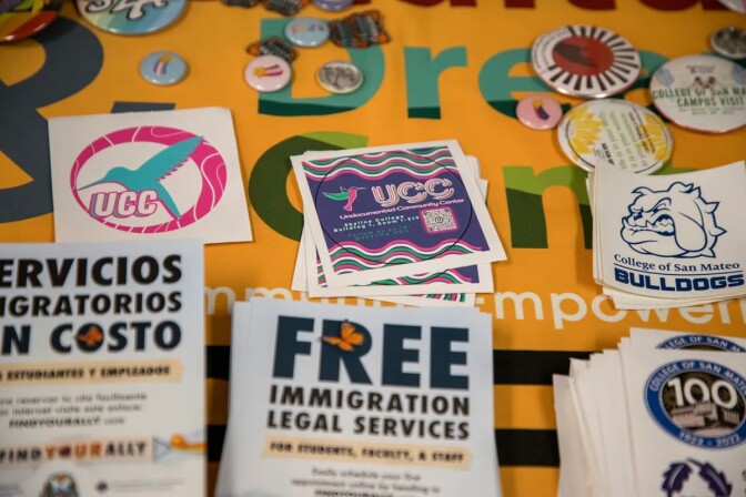 Colorful stickers and small pins lay on a table.