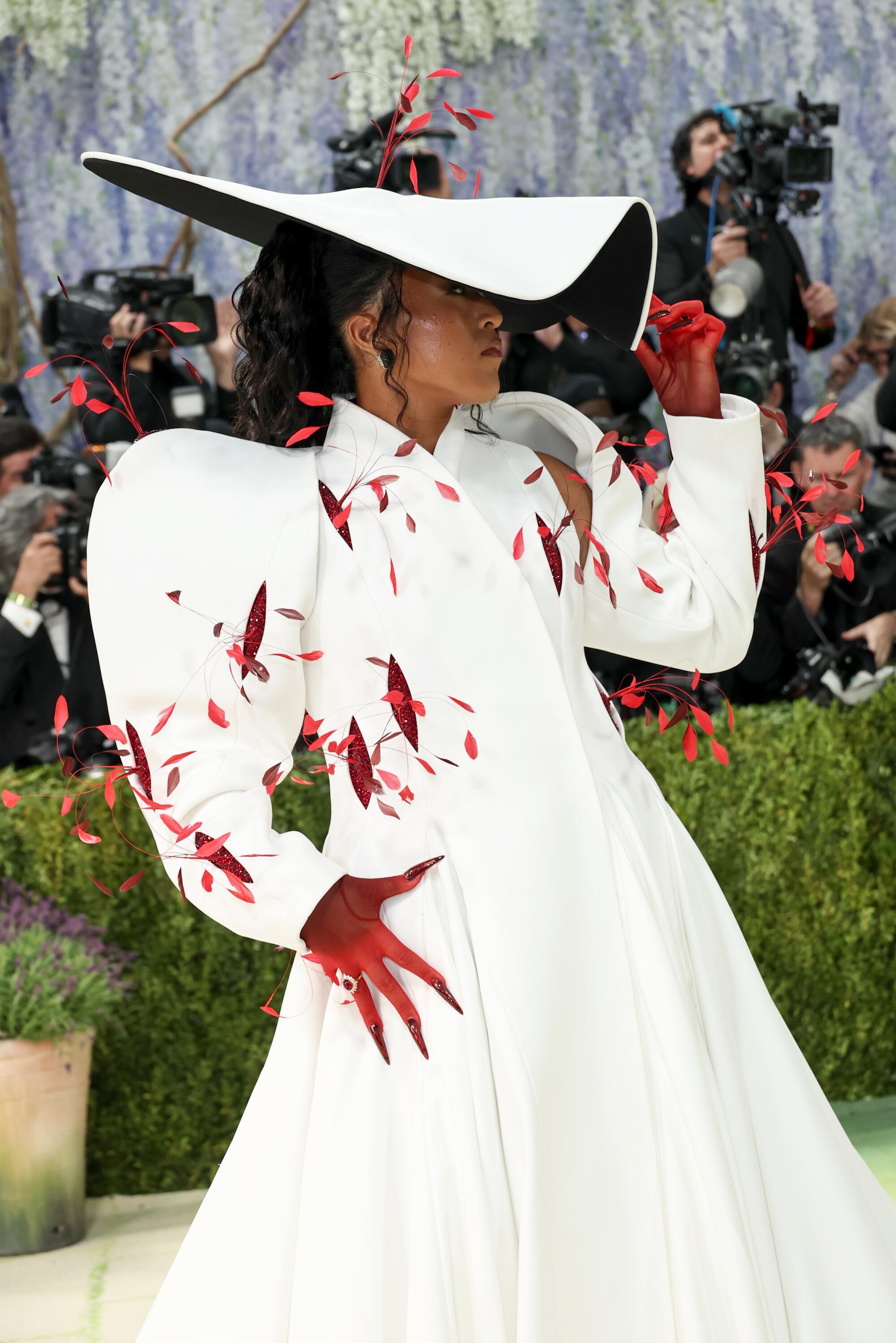 Naomi Osaka wears a white sculptural hat at the Met Gala. 