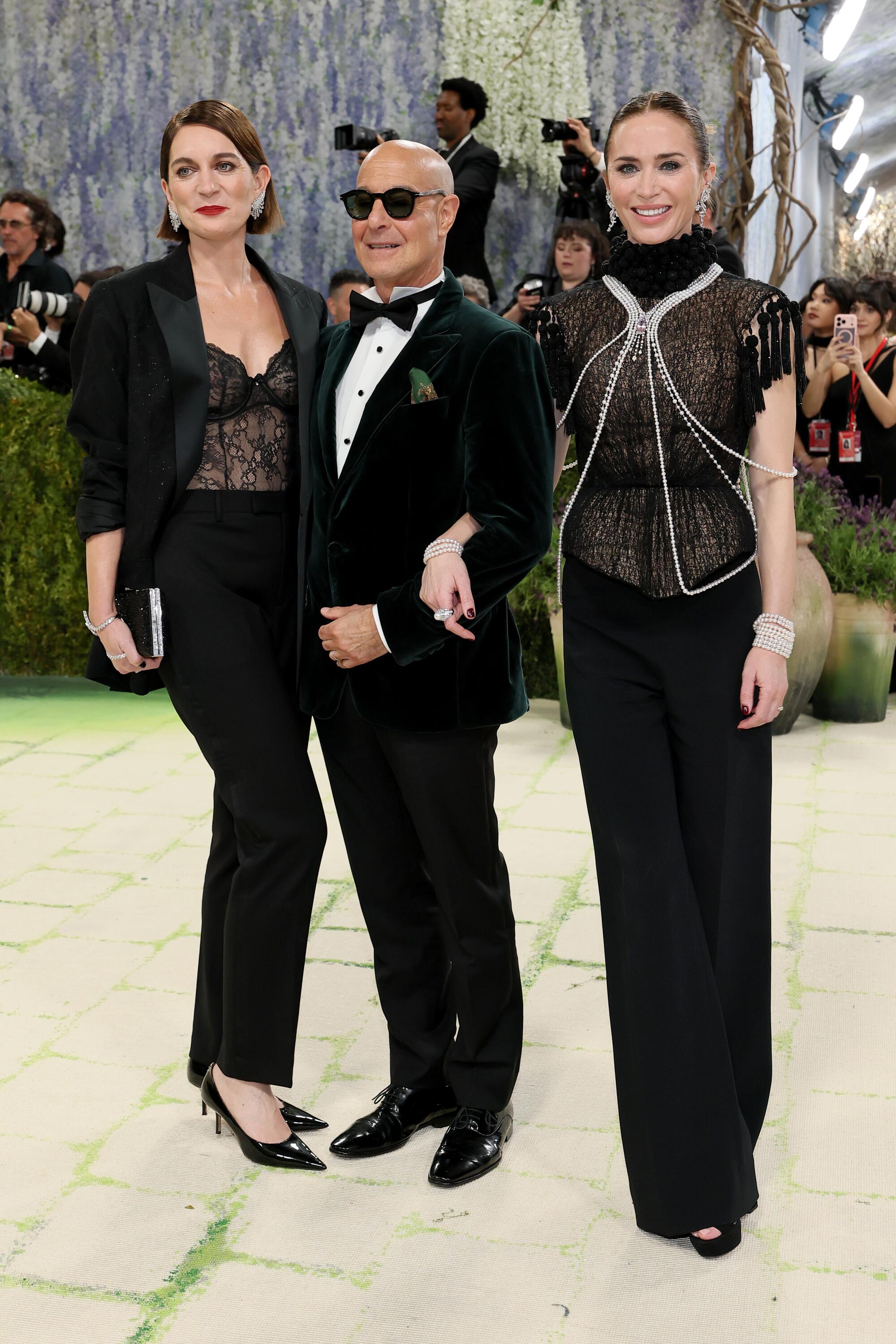 Felicity Blunt, Stanley Tucci and Emily Blunt pose at the Met Gala. 