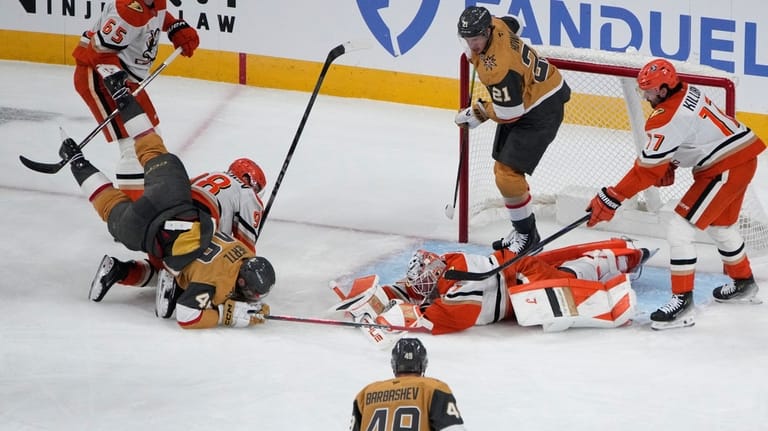 Anaheim Ducks goaltender Lukas Dostal (1) covers the puck against...