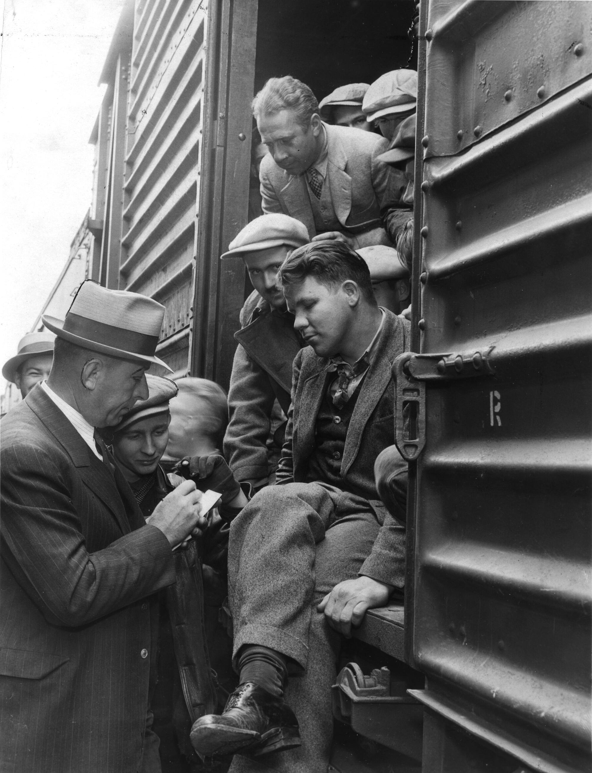 a group of transients aboard a freight train giving data to police officers