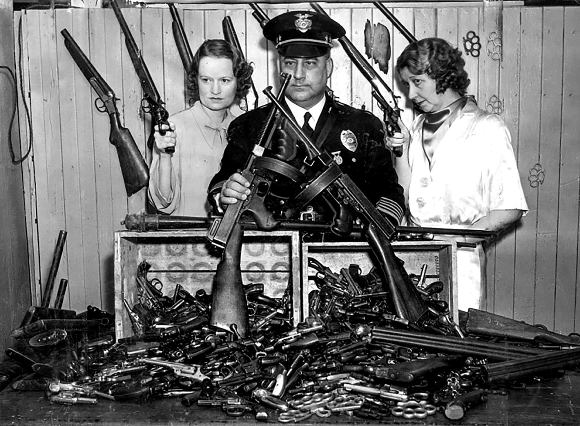 Mona Rehling, James Davis and Mabel Stevens with confiscated guns