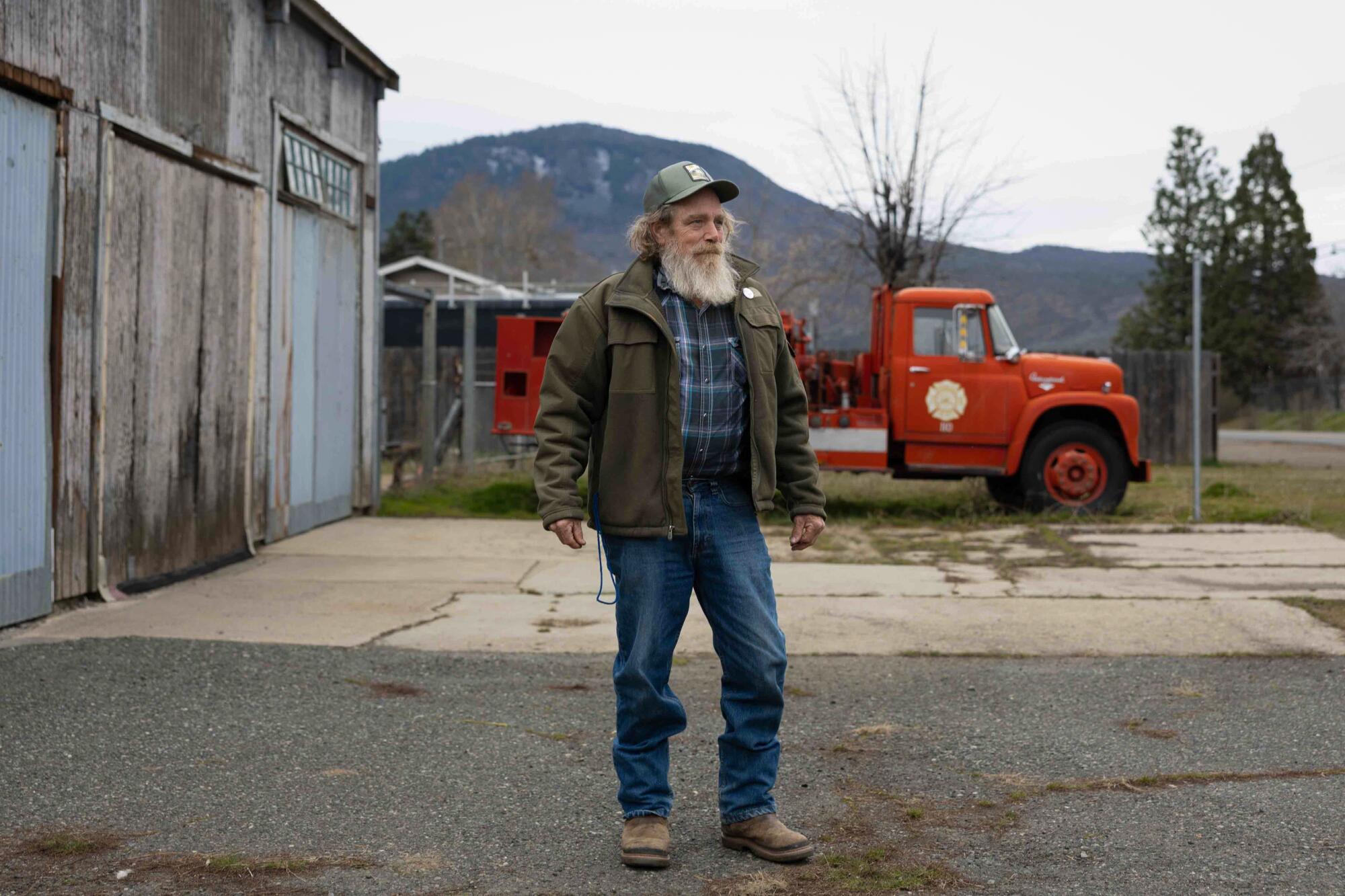 Gary Mellon standing with a red truck in the background