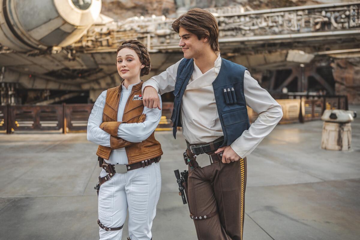 Actors as "Star Wars" personalities in a theme park land. 