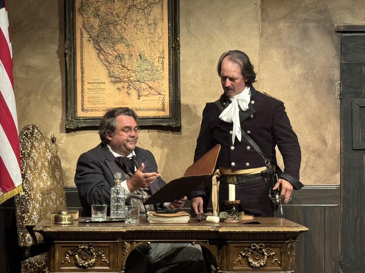 Official Edgar Gordon (Kevin Currie) talks to Captain Soleil (Edward Bangasser) about city issues in "The Return of Zorro."