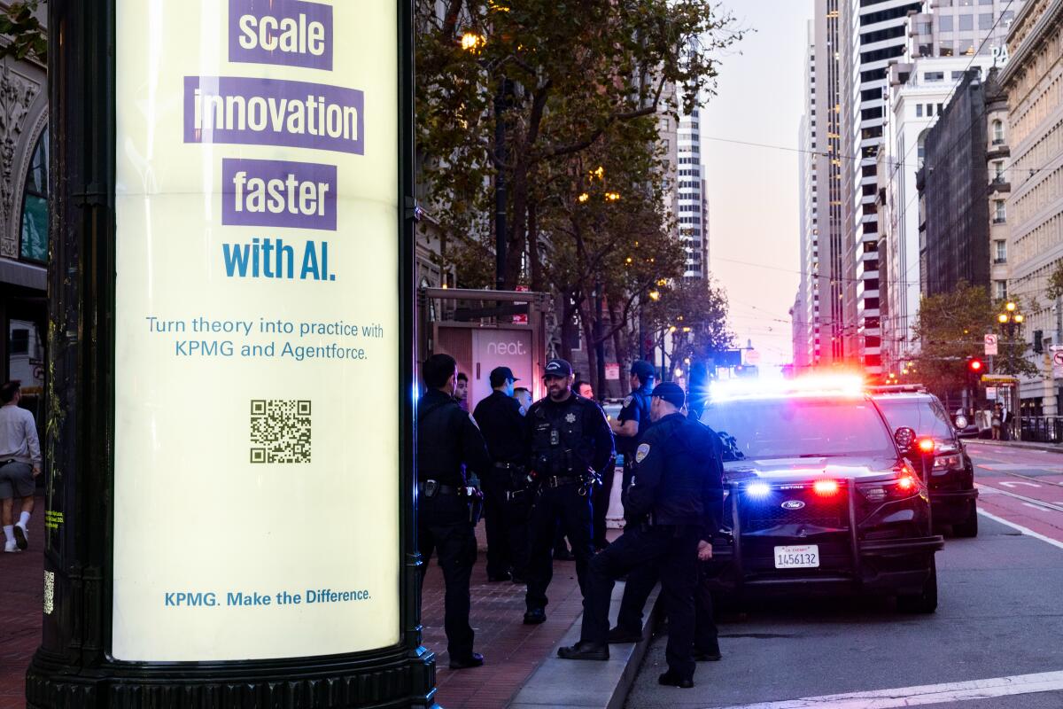 A sign that says "Scale innovation faster with AI" is near people in police uniforms and a police vehicle.