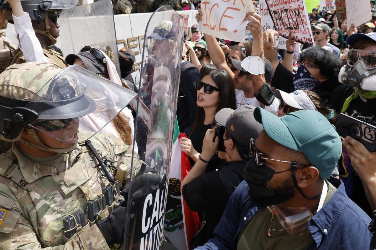 Marines push back anti-ICE protesters in front of the Federal Building