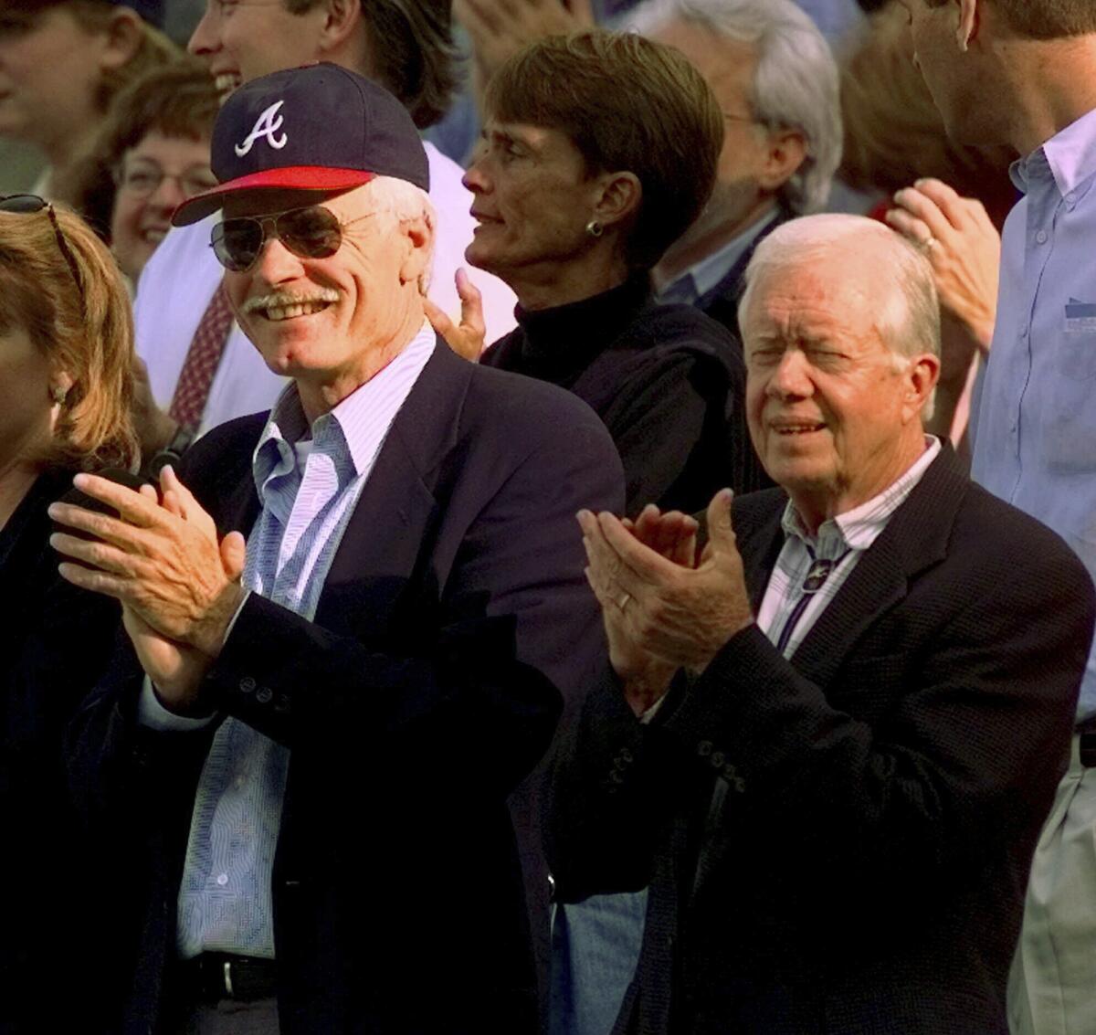 Oct. 1998 photo of former President Jimmy Carter, right, and Atlanta Braves team owner Ted Turner.