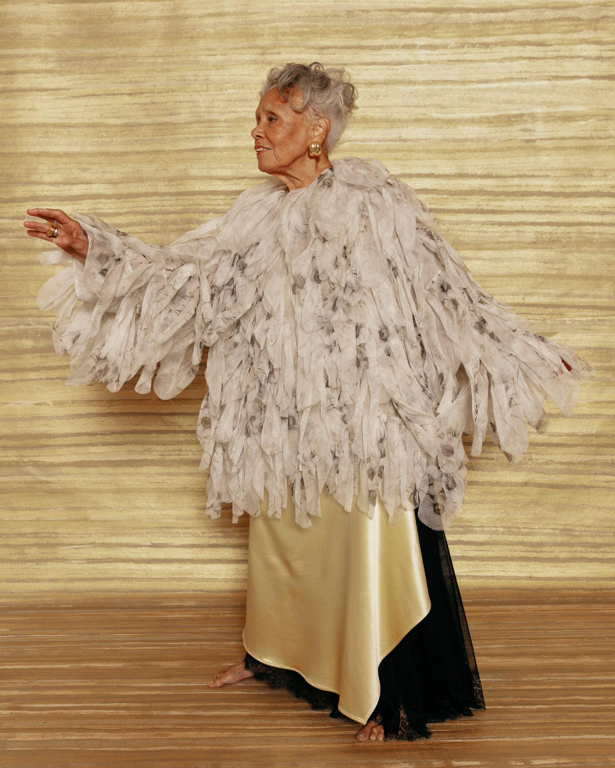 Saar wears a Max Mara jacket, Christian Dior dress and Patricia Von Muslin jewelry.