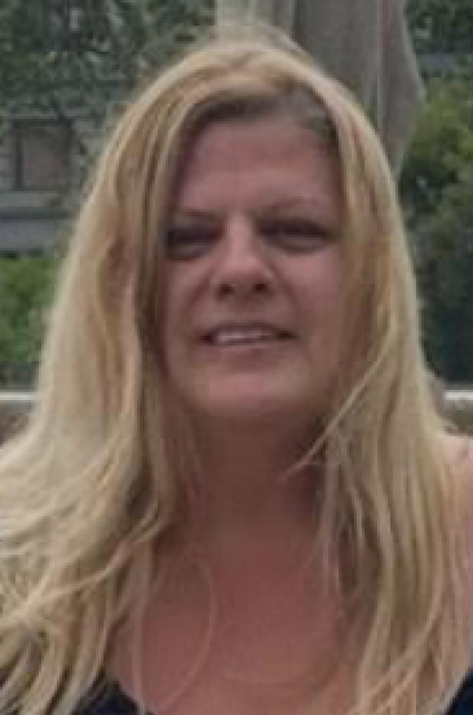 a smiling woman with long, light colored hair