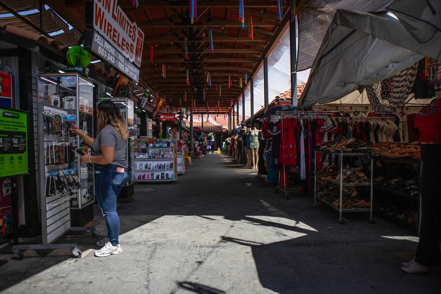 A person organizes their merchandise at a booth at the Mercado Latino Tianguis shopping center in East Bakersfield on April 15, 2026.