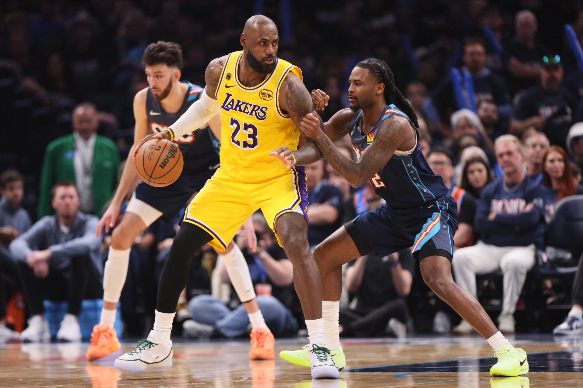 Thunder guard Cason Wallace, right, defends Lakers forward LeBron James, left, during the second half of Game 2.