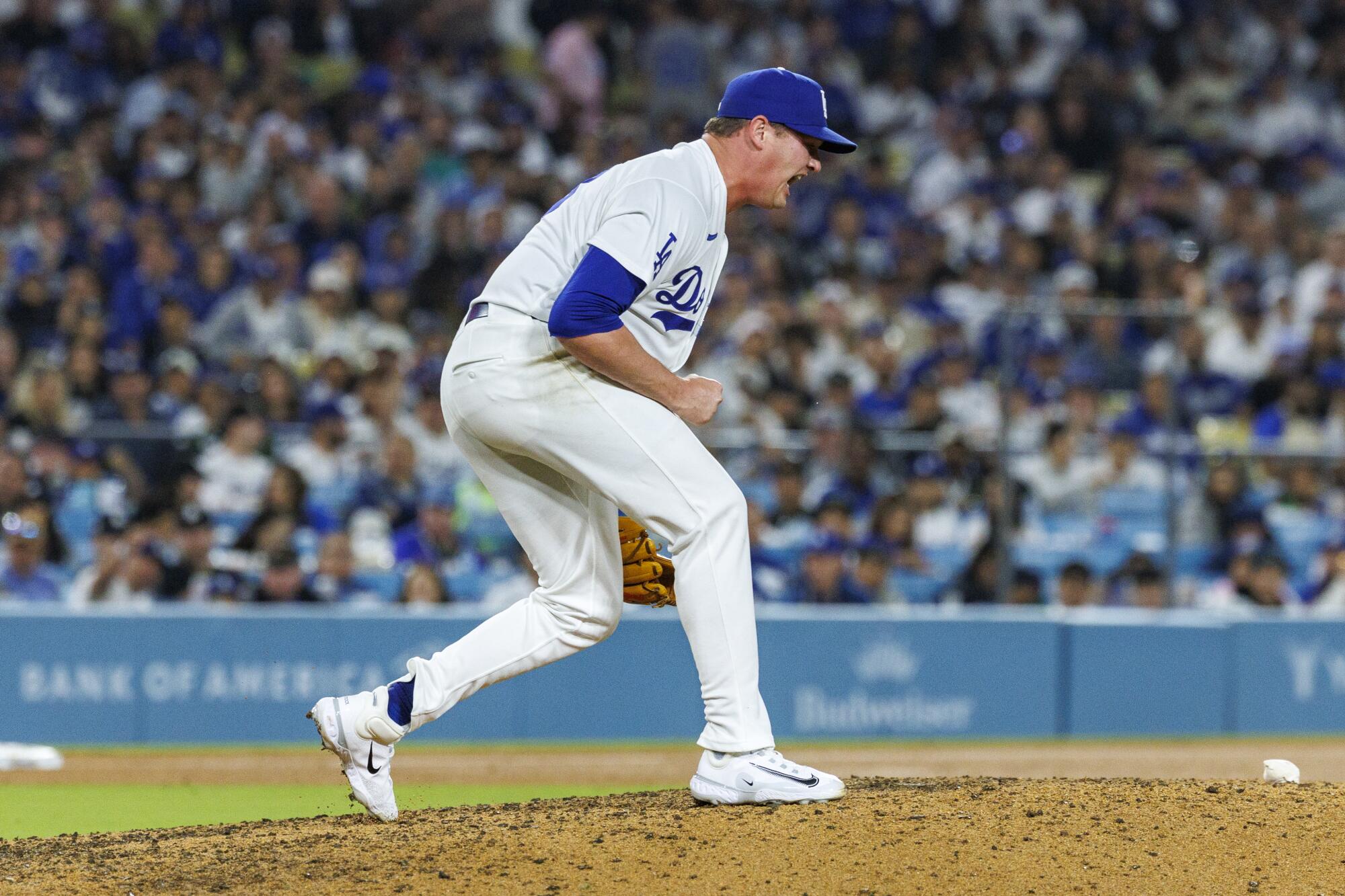 Dodgers reliever Kyle Hurt celebrates after striking out Atlanta's Mike Yastrzemski with two runners on base.