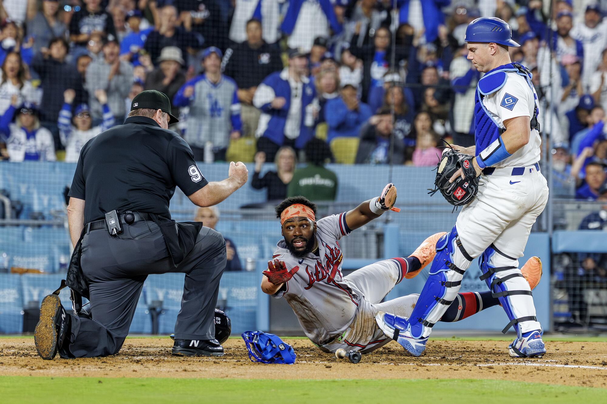 Atlanta's Michael Harris II reacts after being tagged out by Dodgers catcher Will Smith.