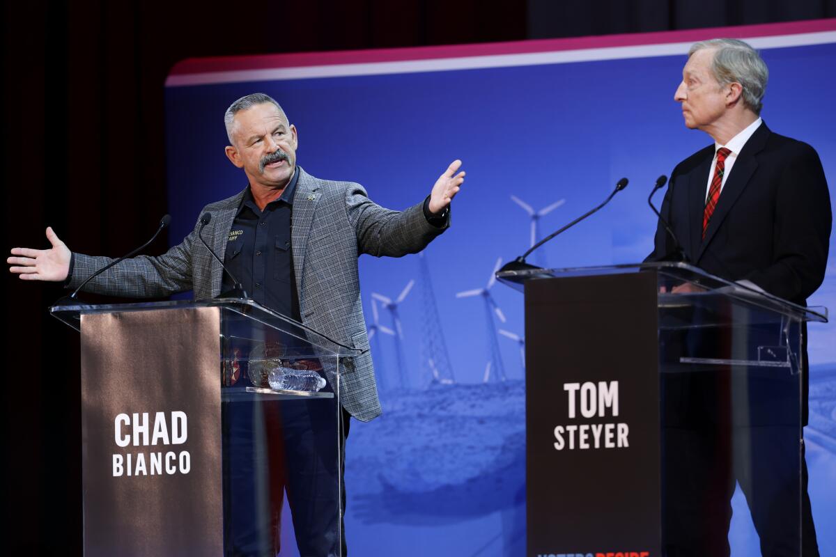 Chad Bianco, left, answers a question as Tom Steyer watches during a gubernatorial debate
