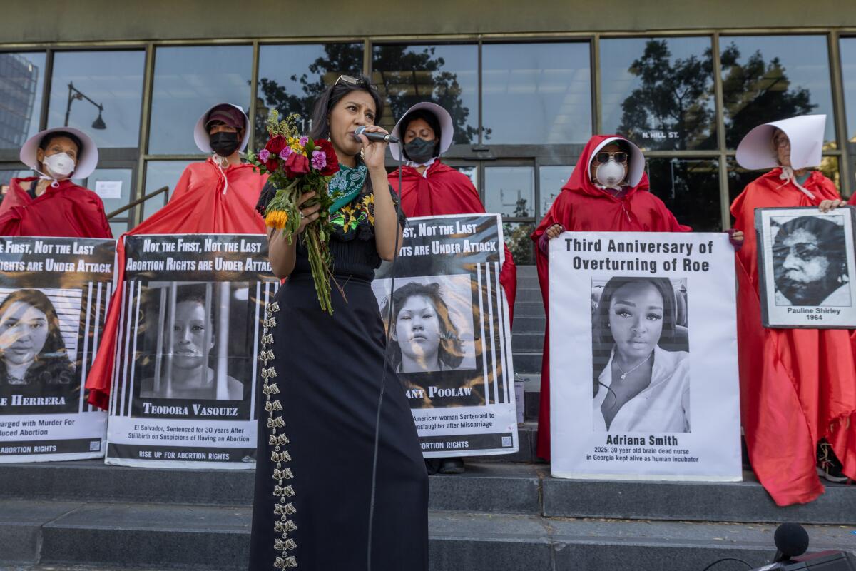 Coral Alonso sings in Spanish as protesters rally on the three-year anniversary of the decision overturning Roe vs. Wade.