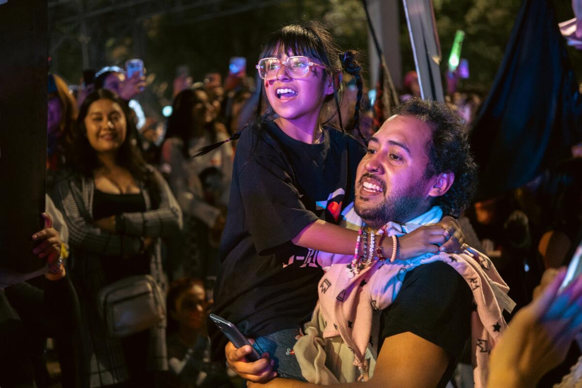 A father and his daughter dance and sing outside